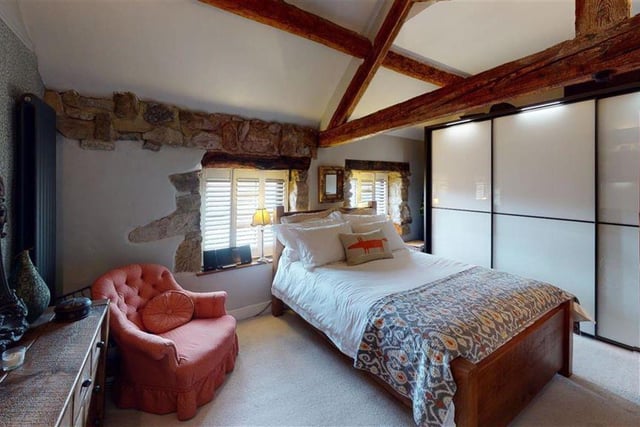 This bedrooms has exposed brick and fantastic beams.