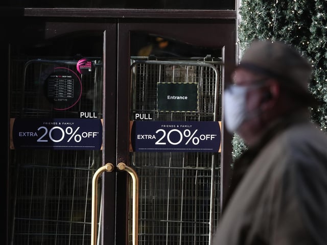 A man walks past the closed House of Fraser store on Buchanan Street in Glasgow.