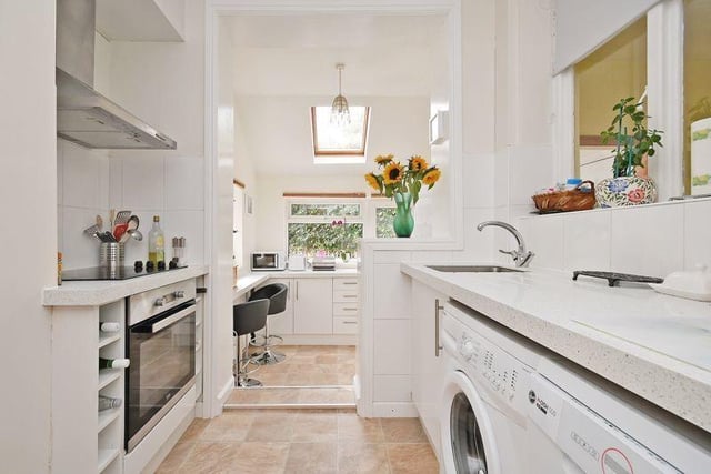 This beautiful modern kitchen snakes around the corner offering loads of room and has direct access to the garden.