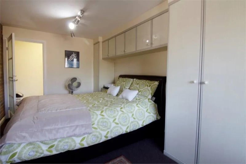 Double-sized bedroom. Ample space for a range of furniture. Front-aspect window. Fitted wardrobes and storage. Fitted carpet flooring.