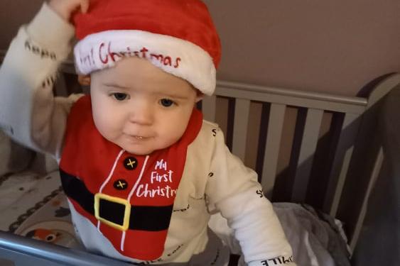 Aaron Joshua Martyn Beever in his Santa hat and festive bib.