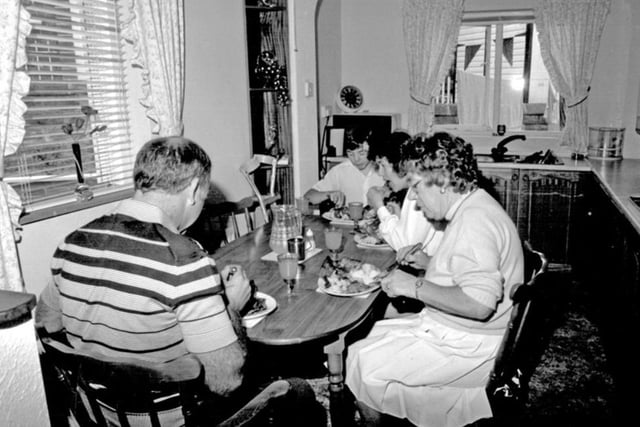 A family gather round the table at a home in Parson Cross, Sheffield, for their traditional Sunday dinner in 1989, when the weekly meal was still an 'institution' on the estate.