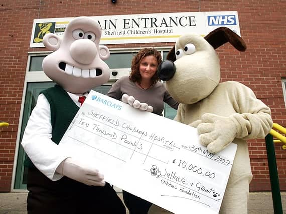 Pictured at Sheffield Children's Hospital are Wallace & Gromit, handing over a giant cheque for £10,000.OO to the hospital's Helen Bailey, on May 30, 2007
