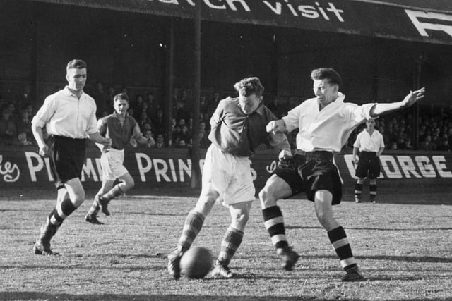 South Shields inside right Swinbanks gets in a shot during the October 1955 FA Cup derby at North Shields but it was off target.