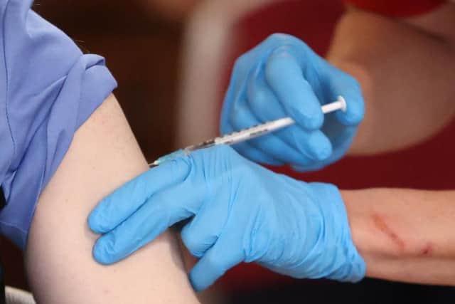 Administering a vaccine.