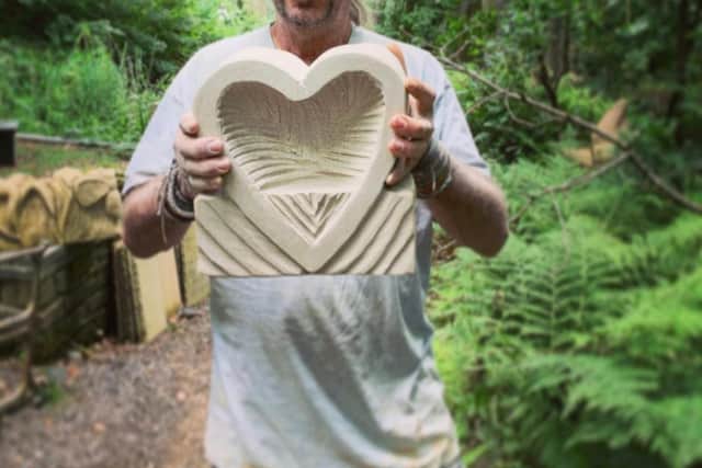 Andrew Vickers with a Loveheart Tea Holder, which weighs about 10-15 kilos and can go on a shelf or in the garden.