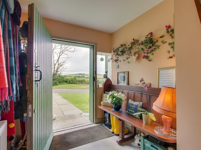 The house is entered via a clapboard porch, added in 1929