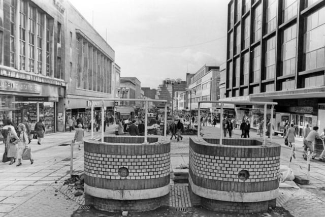 The Moor, Sheffield city centre, in October 1983, showing the old 'Brick Trams' and shops including Quadrant Stationers: Woolworths and Debenhams.