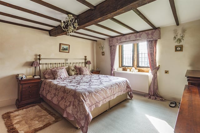 This bedroom on the first floor has exposed beams.