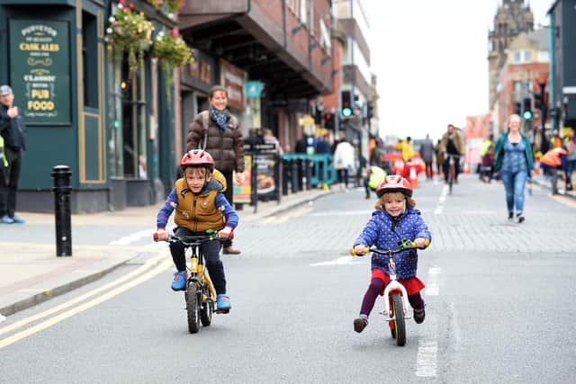 Brother and sister Edward and Grace Daniel enjoying cycling down the middle of Division Street at a car-free streets event last year