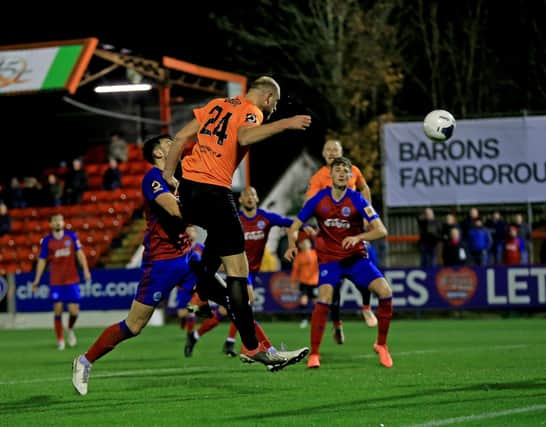 Tom Denton heads in a last minute equaliser away at Aldershot Town.