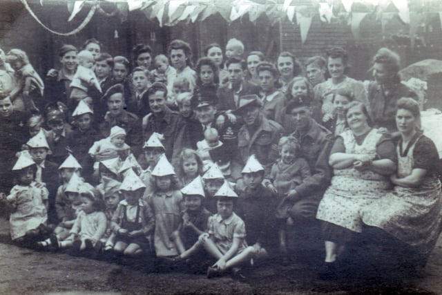 Another picture of the VE Day party in York Road, Darnall. The soldier on left is Alex Swift's father with Alex on his lap