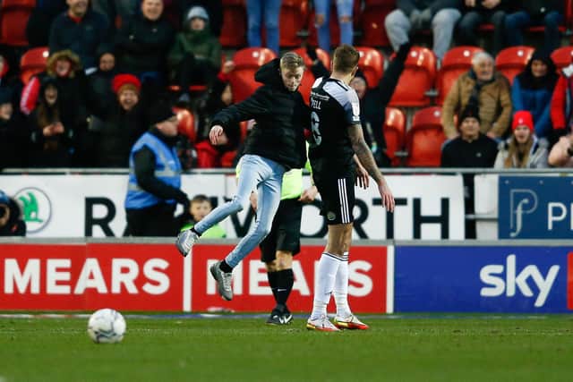 A pitch invader punches Accrington Stanley's Harry Pell during the Sky Bet League One match at AESSEAL New York Stadium, Rotherham: Will Matthews/PA Wire
