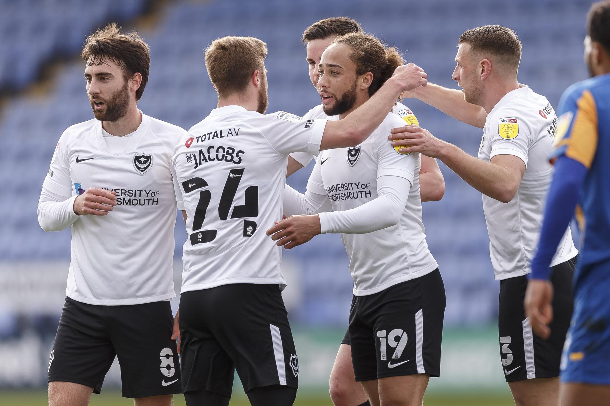 Marcus Harness is congratulated for his opener by his Pompey team-mates.  Picture: Daniel Chesterton