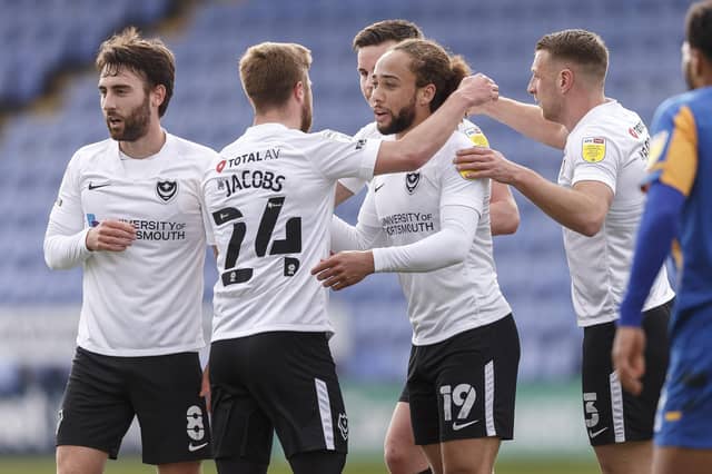 Marcus Harness is congratulated for his opener by his Pompey team-mates. Picture: Daniel Chesterton