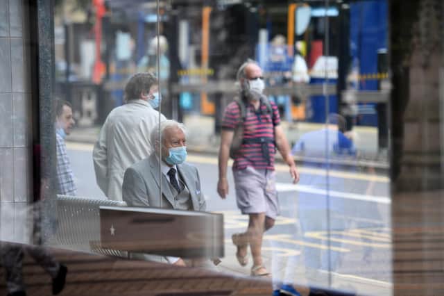 Shoppers wear face masks in Sheffield city centre (Photo by OLI SCARFF/AFP via Getty Images)