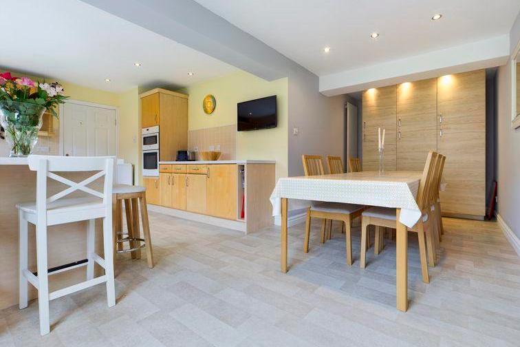 The open plan kitchen/dining room has been extended into part of the garage to provide a super, sociable space with room for a large dining table and a breakfast bar for informal dining too.