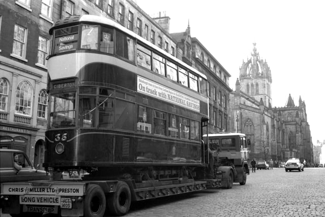 An old no 7 Edinburgh tram on its way to Blackpool travels up the Royal Mile on the back of a lorry in November 1983.