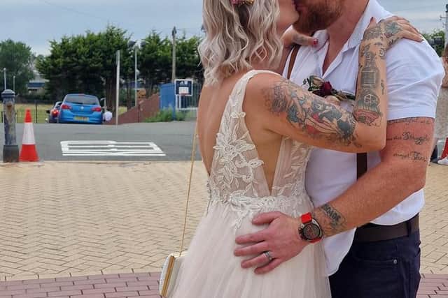 Newlyweds Claire and Will Baggaley share a kiss during their Gavin & Stacey themed wedding day at the bus stop where a famous scene from the show was filmed