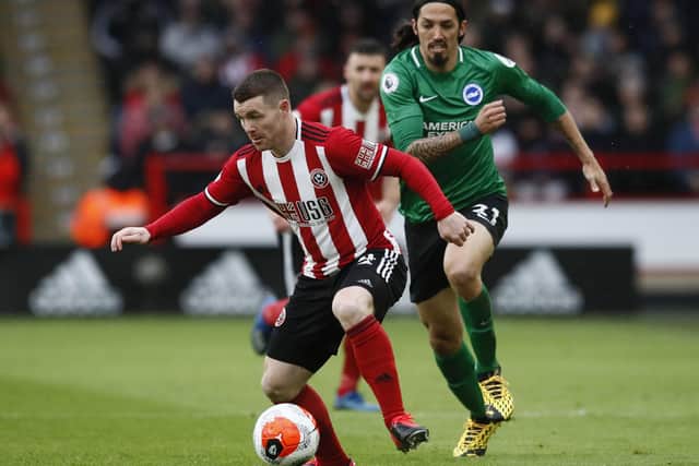 John Fleck of Sheffield United in action with Ezequiel Schelotto of Brighton and Hove Albion during the Premier League match at Bramall Lane, Sheffield: Simon Bellis/Sportimage