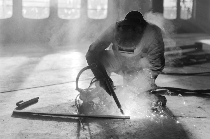 The Queen Elizabeth II liner being fitted out at John Browns shipyard in Clydebank in December 1967 - here a welder works on the floor of the ship. Welders were a pivotal trade along the Clydeside, and one that was a stable and respected trade in Glasgow for generations.