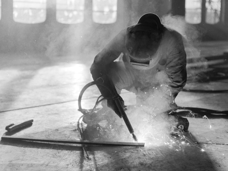 The Queen Elizabeth II liner being fitted out at John Browns shipyard in Clydebank in December 1967 - here a welder works on the floor of the ship. Welders were a pivotal trade along the Clydeside, and one that was a stable and respected trade in Glasgow for generations.