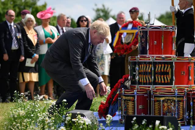 Britain's Prime Minister Boris Johnson (L) lays a wreath during a memorial event to mark the 40th anniversary of the Falklands War at The National Memorial Arboretum on June 14, 2022 in Stafford, England. Photo by Leon Neal - WPA Pool/Getty Images