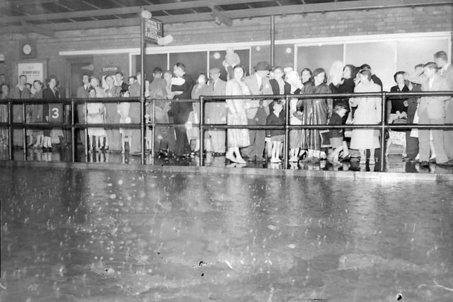 A summer deluge in the early 1950s for these passengers under one of the shelters at the bus station. Photo: Hartlepool Museum Service.