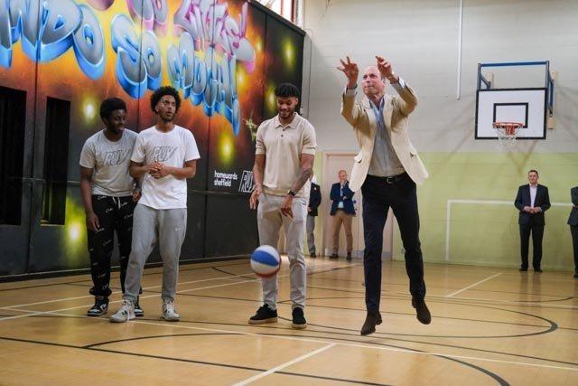 Prince William took a minute to shoot a basketball inside the youth centre - and even scored a hoop, given four or five tries.