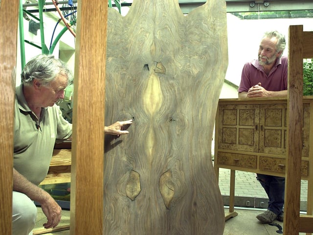 Don Valley Guild of Artists exhibition organiser Dennis Shaw (left), of Kirk Sandall, and cabinet maker Michael Cowie, of Bennetthorpe, with some of Michael's work, and that 300 year-old piece of walnut