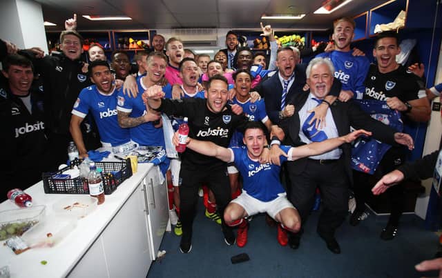 The players toast the success in the dressing room.