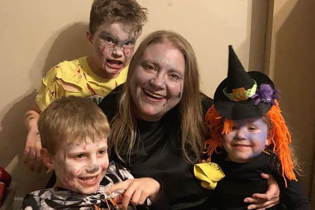 Sarah Crain and her three children on Halloween.