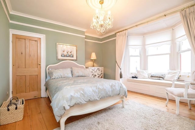 The large bay window in the guest bedroom is the perfect space to enjoy the stunning sea views.