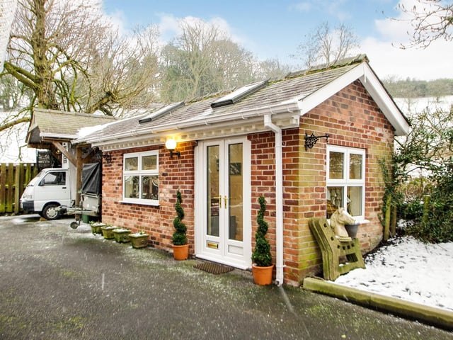 Detached, brick-built office which could be used as a gym or living accommodation, UPVC windows to front and side, four Velux windows, French doors to the side, spotlights to ceiling and wall mounted electric wall heaters.