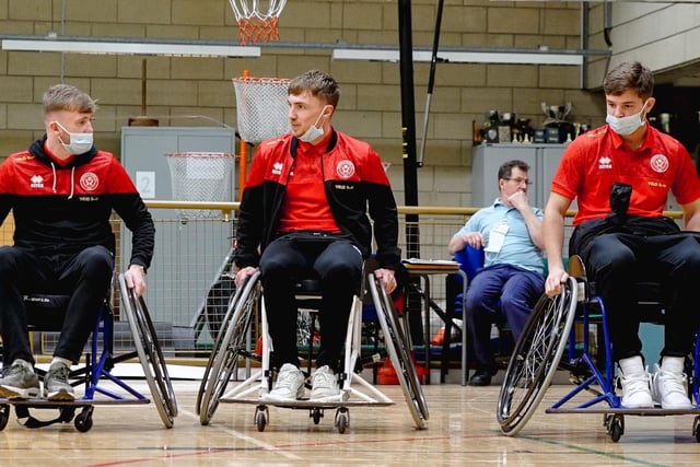 Tommy Doyle, James McAtee and Ben Osborn take part in a wheelchair football session at Northern General Hospital