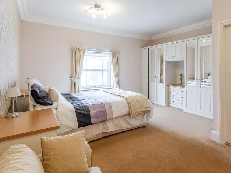 With carpet to flooring, central heating radiator, built-in wardrobe and window to the rear elevation.