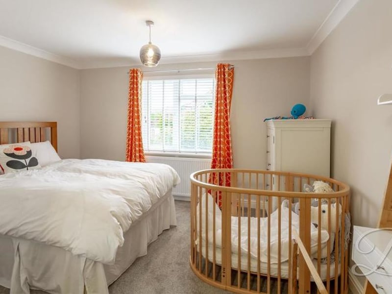 A smaller bedroom, but no less stylish. Again, the floor is carpeted and a window to the front offers plenty of light.