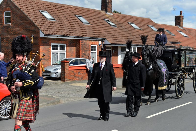 Bag piper leads the funeral procession for Monkton Village store Gladys Stonehouse.