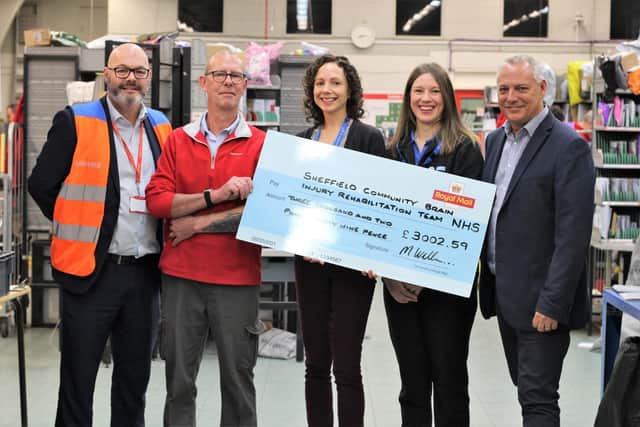 Iain Barker and his Royal Mail colleagues deliver the cheque.