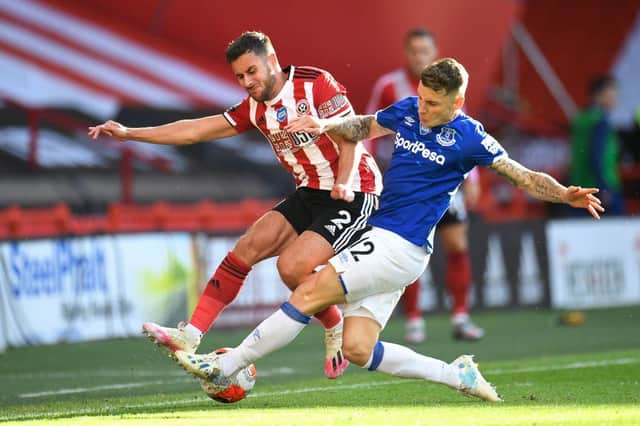 Sheffield United's George Baldock (L) vies for the ball with Everton's Lucas Digne  during the English Premier League football match between Sheffield United and Everton at Bramall Lane (Photo by PETER POWELL/POOL/AFP via Getty Images)