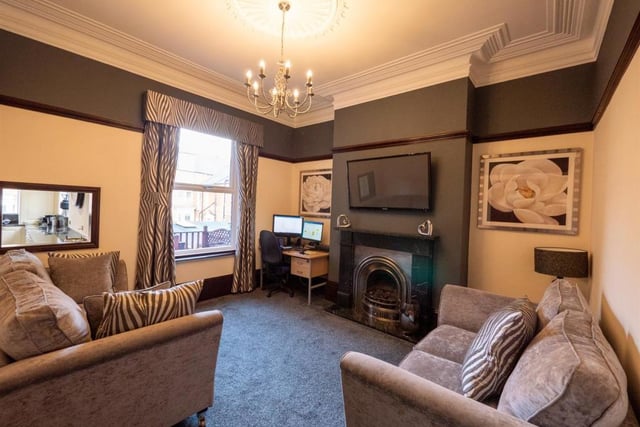 The sitting room includes a feature fireplace with gas fire.