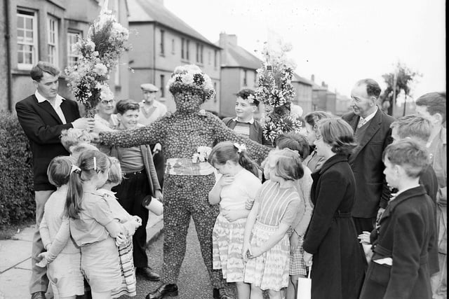 The Burryman Mr J Hast leaves his home to go round the town in his fancy dress at the Queensferry Fair in August 1960.