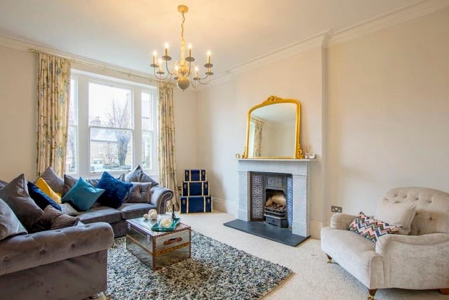 The marble fireplace and its tiled surround catches the eye in the living room.