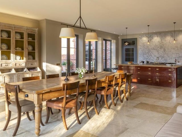 The kitchen/breakfast room at Baughurst House is a truly outstanding space, with incredible ceiling height, and is flooded with light via multiple French doors, which lead outside on to a terrace. As well as modern appliances, there is even an adjoining, air-conditioned larder.