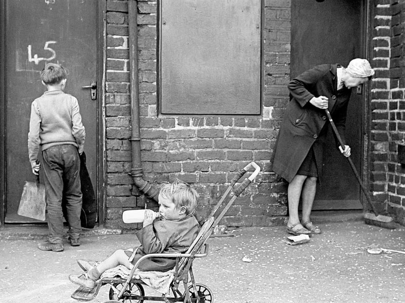 Mrs Tandy cleaning her backyard, Sheffield, in 1969