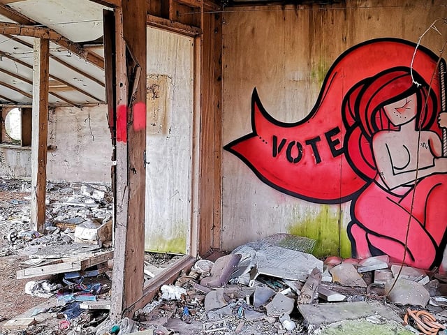 Bright street art sits among the rundown property.