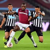 West Ham United's Michail Antonio battles for the ball with Newcastle United's Isaac Hayden (left) and Jamaal Lascelles (right) during the Premier League match at London Stadium. Michael Regan/PA