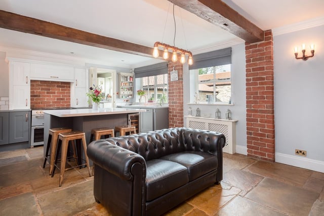 The original brickwork alongside the wooden beams are wonderful features of the kitchen, while the large stone flagged flooring finishes off the space beautifully.