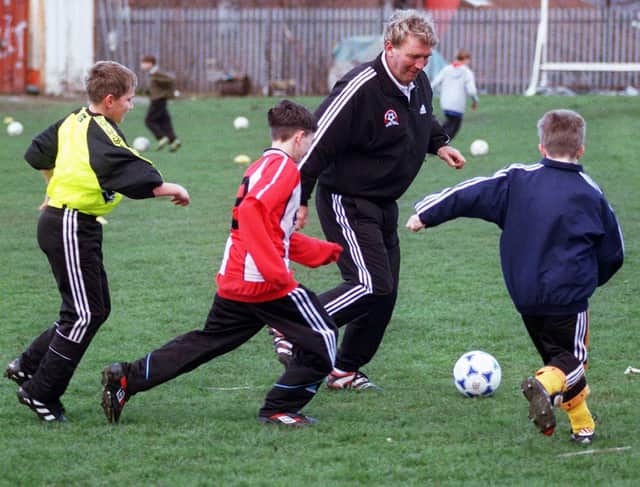 Sheffield United legend Tony Currie takes on some of the youngsters at his soccer school held at Sheffield Works Ground during the April 1999 half term holidays