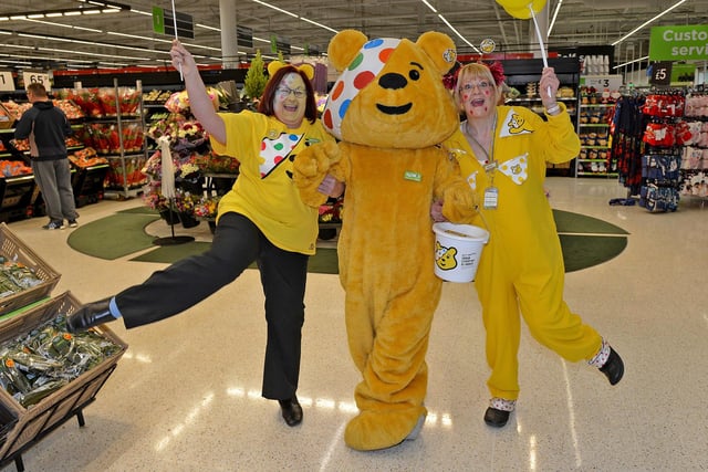 What a magnificent Marina Way memory! Community champion Jackie Carroll (left) and Karen Milburn dance with Pudsey Bear in the aisle of Asda in 2017.